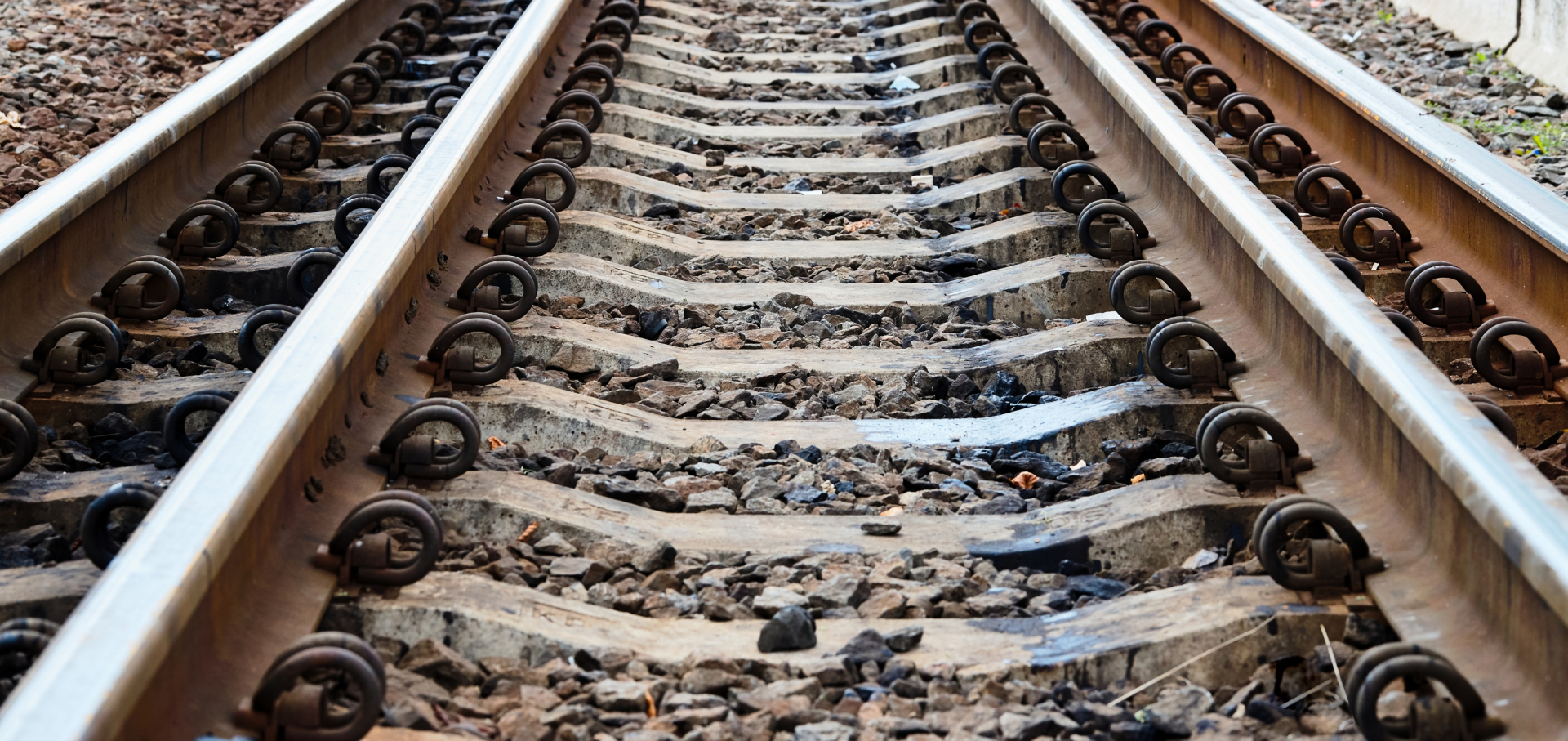 Why do railway tracks have stones underneath?